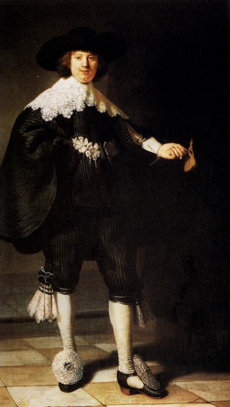 Full-length portrait of Maerten Soolmans standing on a tiled floor in black satin with lace collar and cuffs, wide-brim hat, large rosette shoe ornaments, and a glove in his extended hand, illuminated from the left, painted by Rembrandt in 1634.