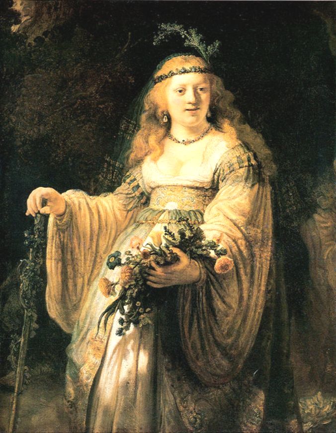 Rembrandt’s Saskia dressed as an Arcadian shepherdess, crowned with flowers and veil, holding a bouquet and staff; golden, ivory, and green tones glow in soft light against a dark, leafy background.