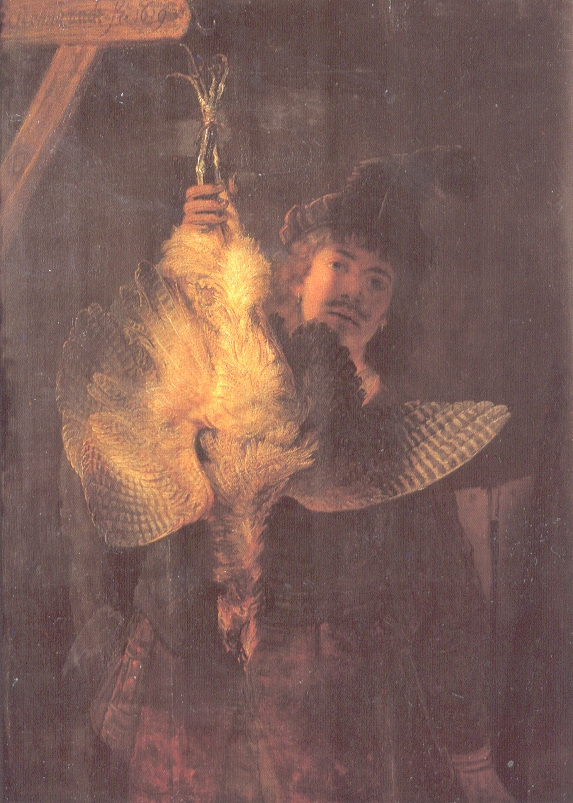 Rembrandt stands in shadow holding an upside-down bittern; the bird’s bright belly and spread wings dominate the dark canvas while the artist’s face appears behind it, creating a dramatic contrast of glowing plumage and subdued human presence.