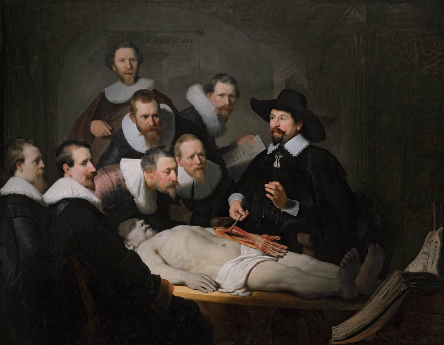 In a dark lecture hall, Dr. Nicolaes Tulp demonstrates the tendons of a cadaver’s forearm to seven ruff-collared colleagues gathered around a table; a beam of light illuminates the anatomist’s face, the white collars, and the pale, foreshortened body while an open book lies at the lower right.