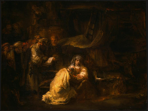 Dimly lit interior by Rembrandt showing Mary in luminous white cradling the infant Jesus while a priest reads beside an open book and onlookers gather; warm golden light touches faces, cloth, and pages within deep brown shadows.