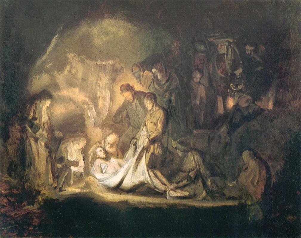 Lamplit scene by Rembrandt showing figures lowering Christ’s body onto a white shroud inside a dark tomb; a circle of mourners bends and kneels while the surrounding cave dissolves into shadow.