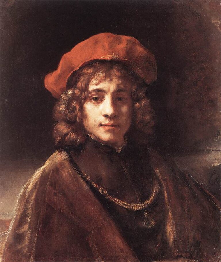 Half-length portrait of a young man in a soft red cap facing three-quarters toward the viewer; warm light models his face and curls while a simple chain and brown robe recede into a dark, velvety background.