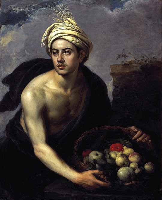 Baroque painting of a bare chested young man in a pale turban holding a basket filled with assorted fruit, his body lit against a dark background with a glimpse of cloudy sky at the top.