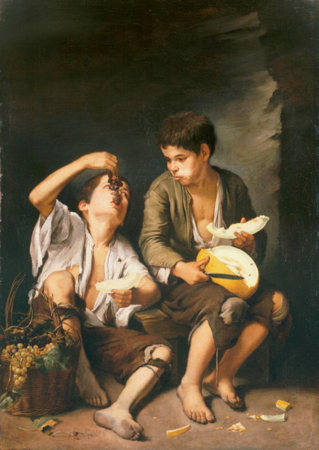 Baroque painting of two barefoot boys in torn clothing sitting on the floor eating fruit, one leaning back to drop grapes into his mouth and the other holding a sliced melon, with a basket of grapes and scattered rinds at their feet against a dark background.