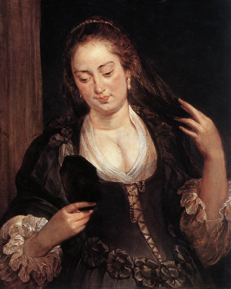 Baroque portrait by Peter Paul Rubens depicting a young woman in a dark dress with white ruffled sleeves, holding a small mirror in one hand and lifting her hair with the other, her gaze turned downward in quiet contemplation against a dark background.