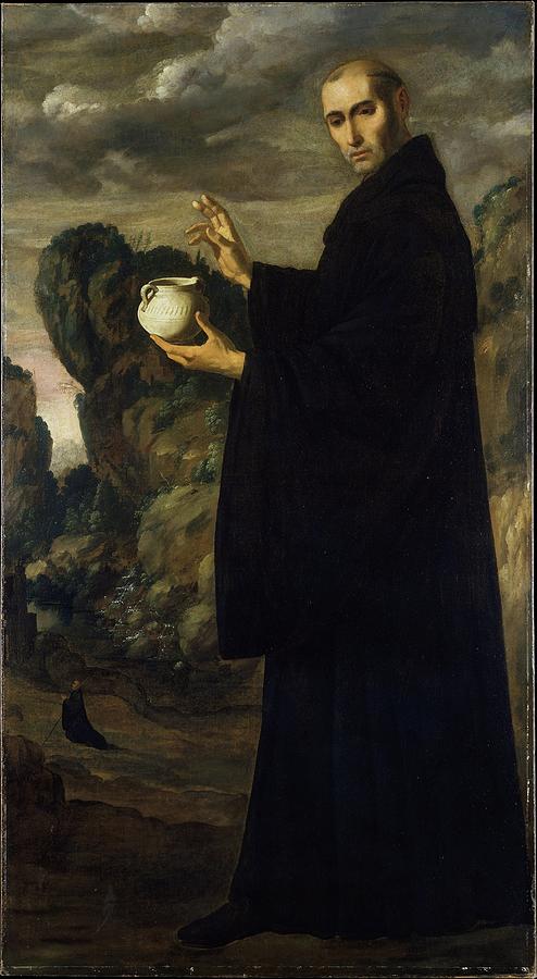 Full length figure of Saint Benedict in a black monastic habit standing in a rocky landscape under a cloudy sky, holding a white jar in one hand and raising the other in a gesture of blessing, with a tiny kneeling monk visible in the distant valley.