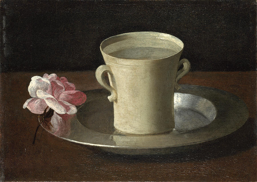 A small Baroque still life by Francisco de Zurbaran showing a plain white handled cup filled with water standing on a silver plate, with a single pink and white rose lying beside it on a wooden table against a dark background.