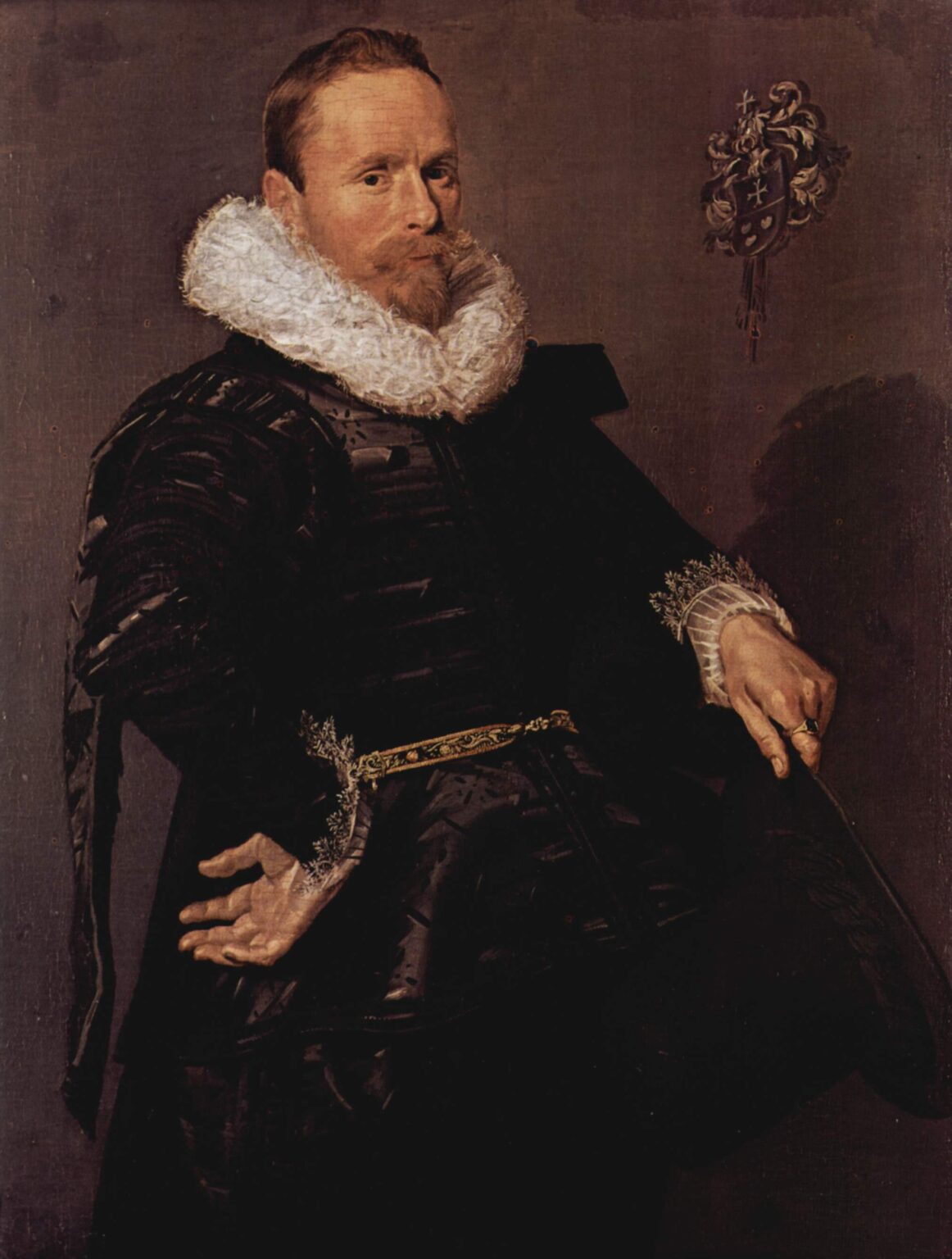 Seated man in black clothing with a large white ruff and lace cuffs, leaning back with one hand open and the other holding a cane, with a small heraldic crest on the wall behind him, painted by Frans Hals in 1618.