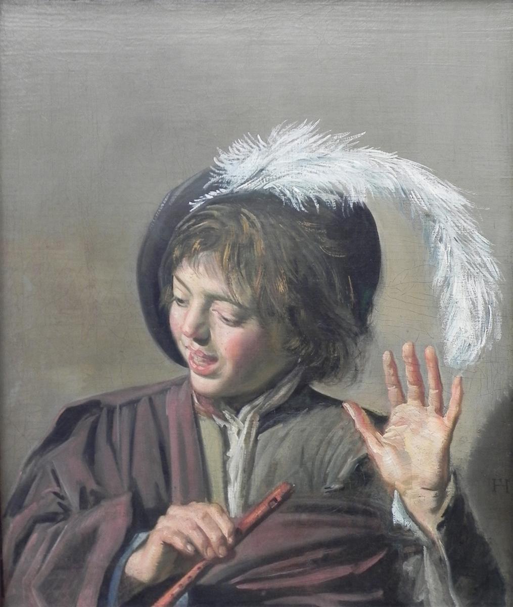 Frans Hals, Singing Boy with a Flute (1623), close-up portrait of a singing child wearing a feathered hat, holding a flute across the chest and raising one hand in a musical gesture against a plain gray background.