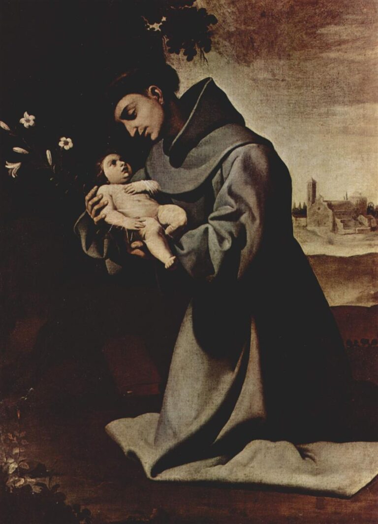 St. Anthony of Padua in a grey Franciscan habit kneels in a dark interior, gently holding the nude Christ Child in his arms while white lilies rise behind him and a small church appears in the softly lit landscape to the right.