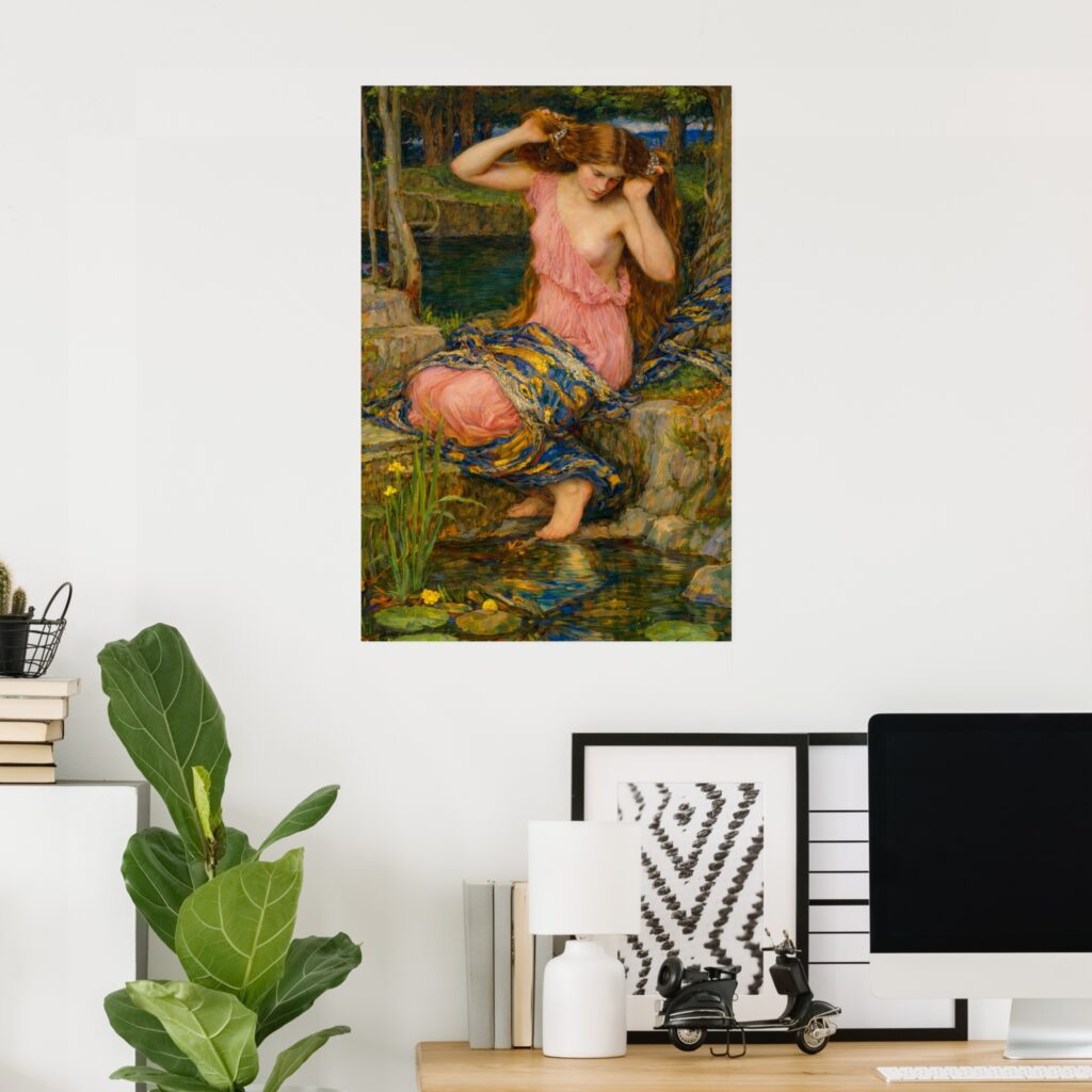 Poster of “Lamia” by John William Waterhouse hanging on a white wall in a modern home office, above a desk with a computer, framed prints, books, and a green indoor plant.
