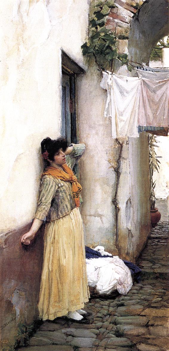 A young woman in a long yellow skirt and orange scarf leans against a pale plaster wall beside a dark doorway, resting in a cobblestone courtyard with white laundry hanging under an arch and a pile of clothes at her feet.
