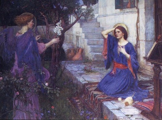 John William Waterhouse, The Annunciation (1914), angel in purple offering white blossoms to kneeling Mary in blue with a halo on stone steps beside a shadowed garden and pale courtyard wall.