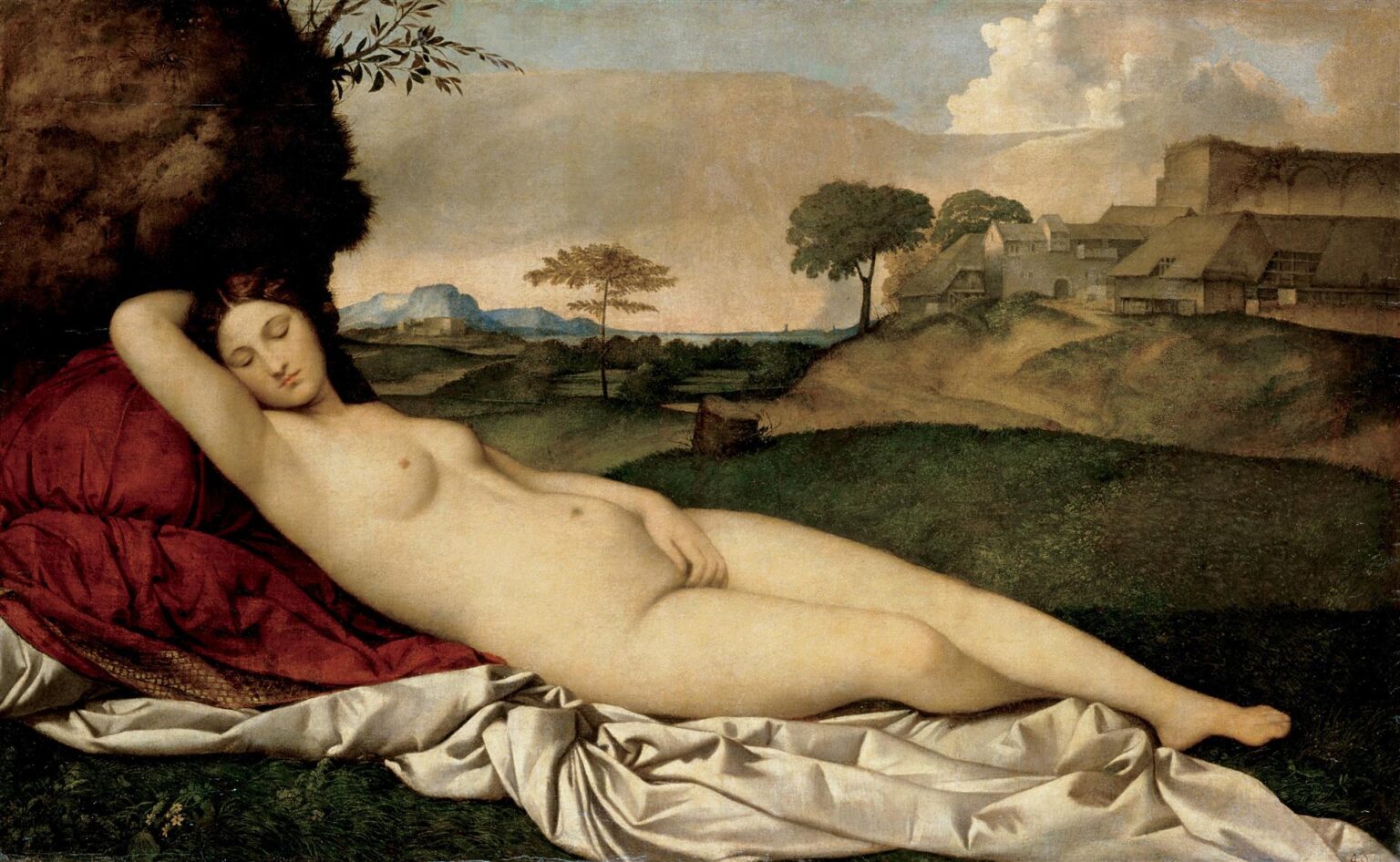 Giorgione’s “The Sleeping Venus” shows a nude goddess asleep on red and white drapery in a calm landscape, with rolling hills, trees, distant buildings, and a softly lit sky behind her.