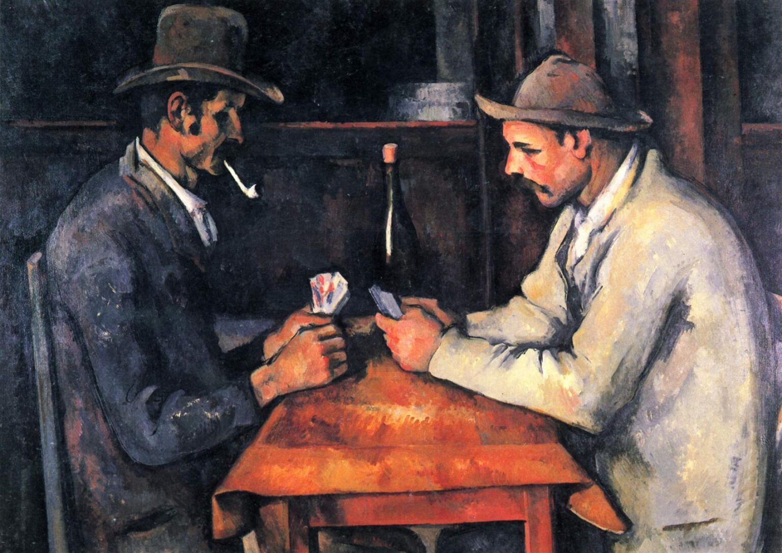Paul Cezanne’s “The Card Players” showing two rural men seated across a wooden table, quietly focused on a card game in a dark interior with a bottle placed between them.